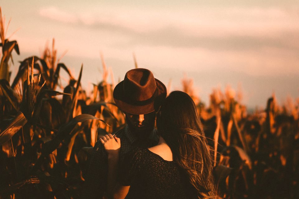 man and woman hugging each other in the field photo