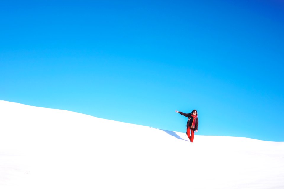 woman standing on white snow field during daytime