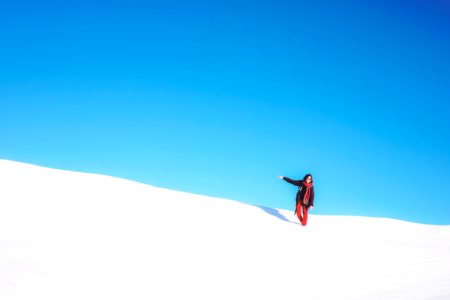 woman standing on white snow field during daytime photo