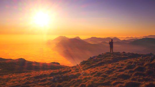 person standing on mountain photo