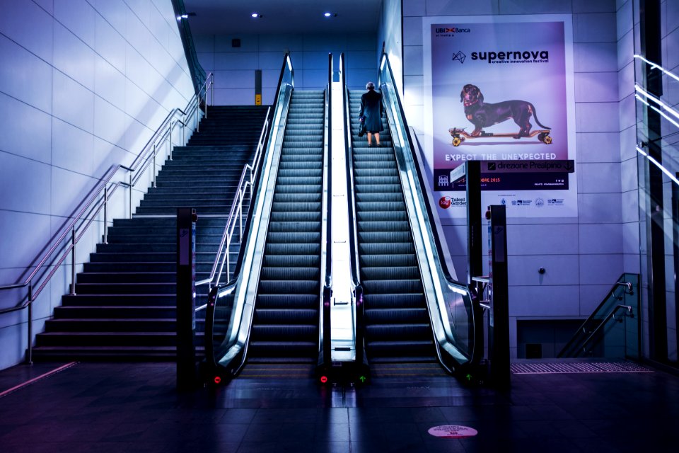 woman standing on escalator