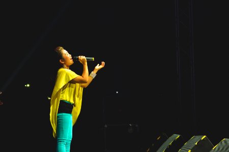 woman holding a microphone performing on stage photo