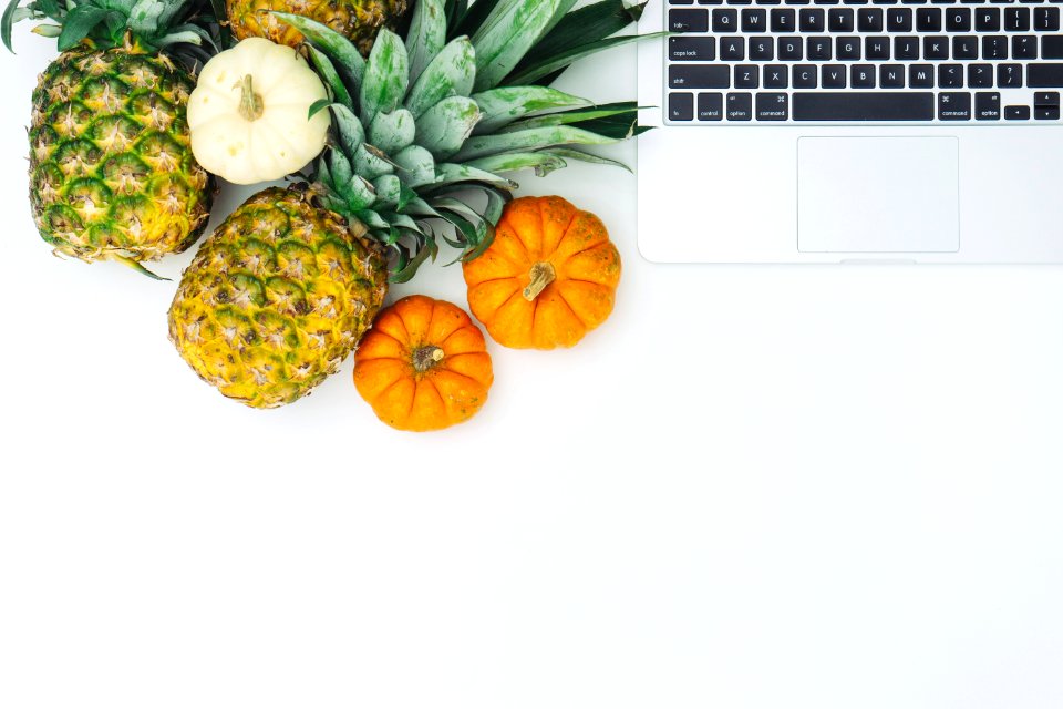 green pineapple fruit near MacBook