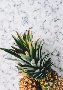 two pineapple fruits on white surface photo