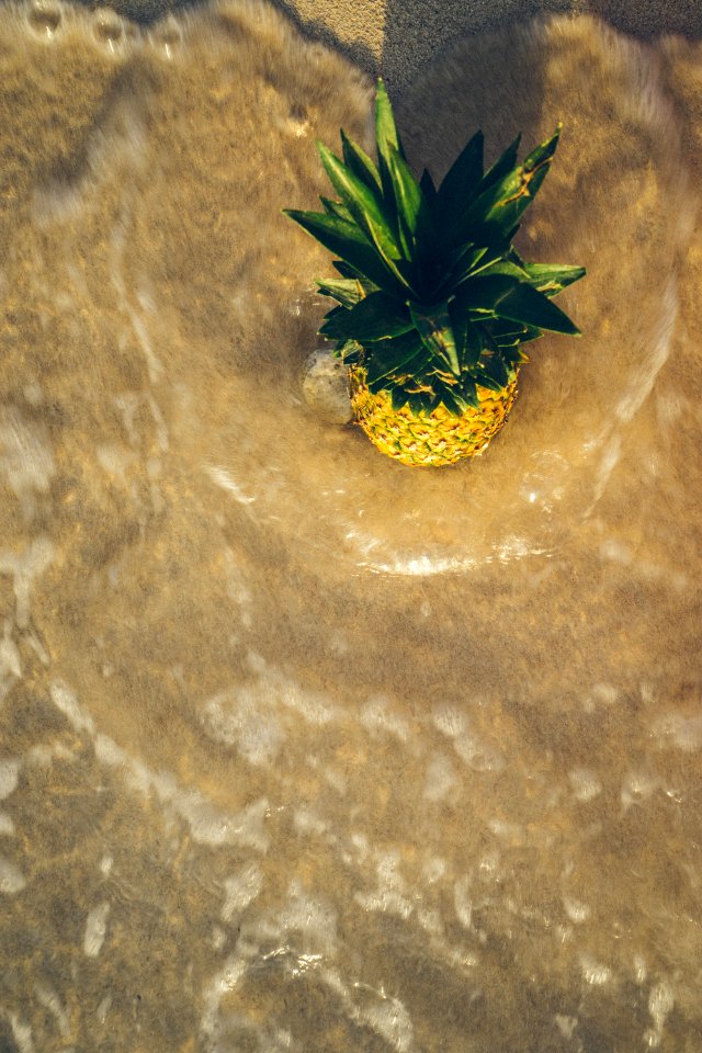 pineapple on brown surface