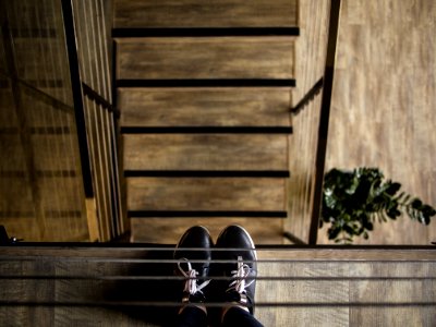 person standing near railing looking down photo