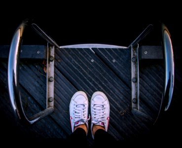 person wears pair of white low-top sneakers photo