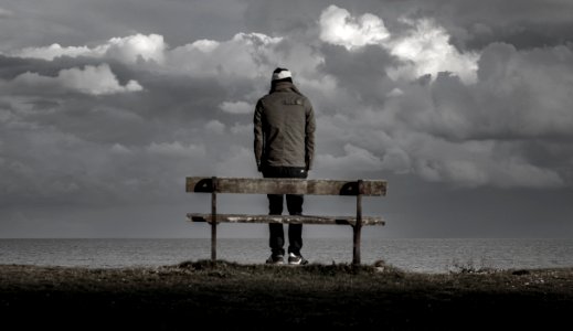 man standing near bench