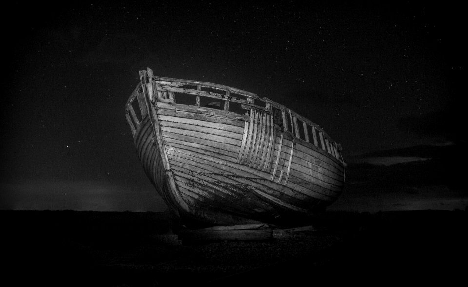 wrecked boat in monochrome photo