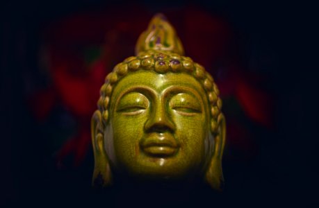 green ceramic buddha head photo