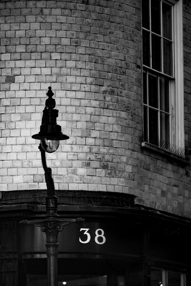 grayscale photo of metal light street post