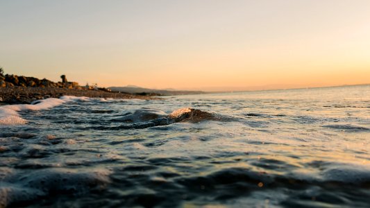 low angle photography of ocean wave at beach photo