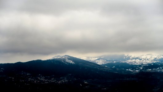 black rocky mountain under white cloudy sky during daytime photo