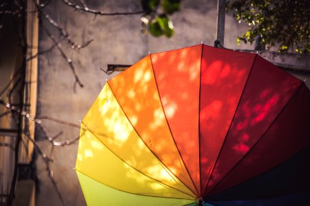 multi-colored umbrella hanged on pole photo