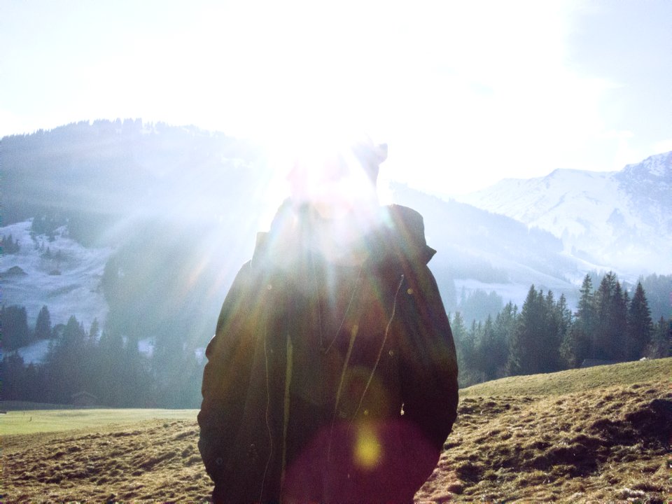 silhouette of person facing mountain range