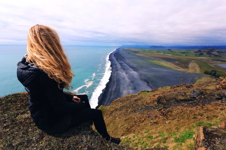 woman looking at seashore photo
