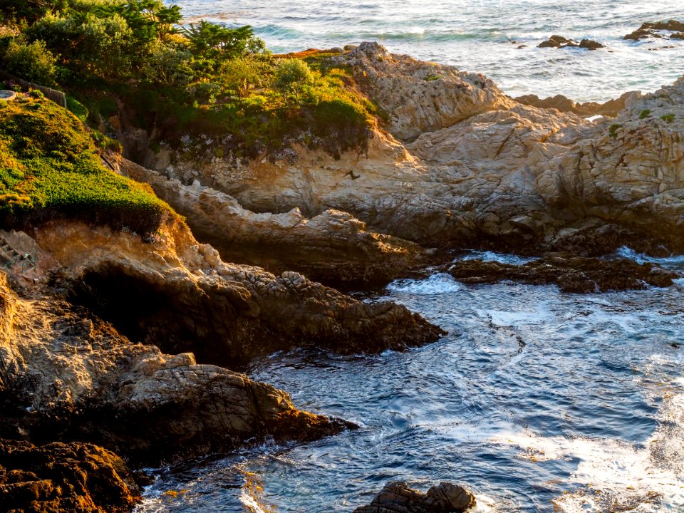 aerial photo of rocks near body of water