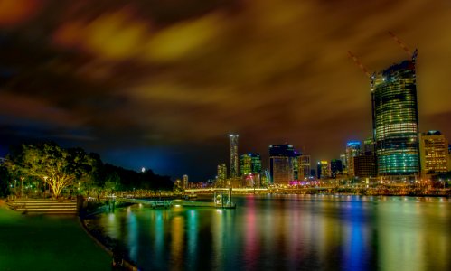 city lights reflecting on body of water