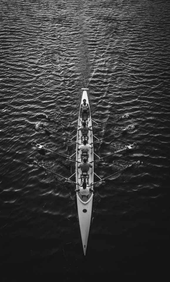 people riding boat on body of water