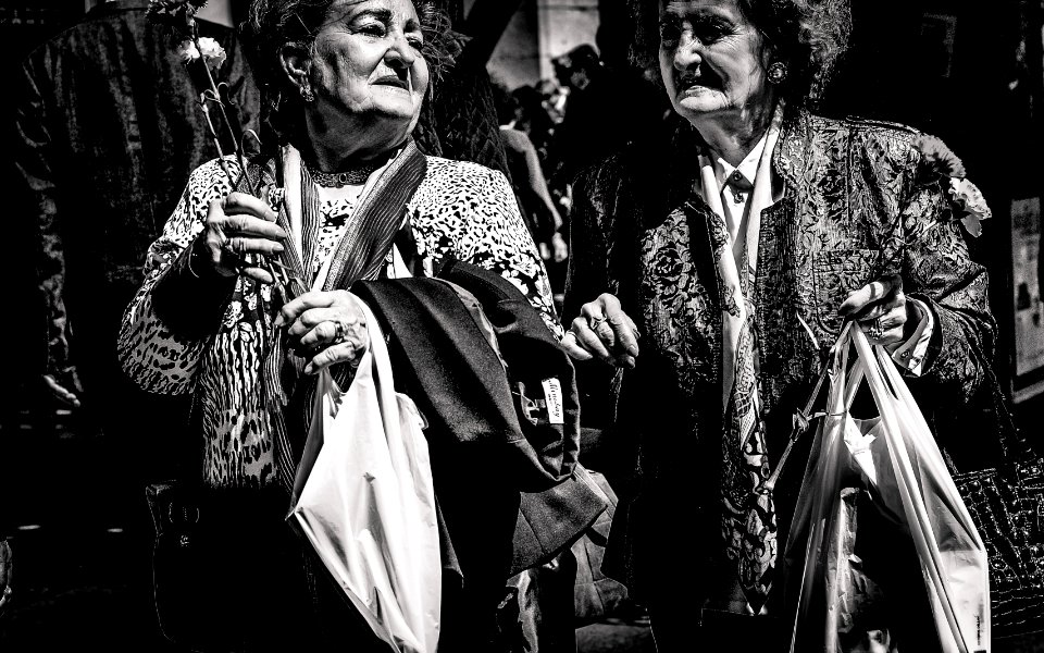 grayscale photo of two women holding bags