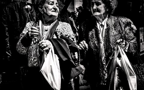 grayscale photo of two women holding bags