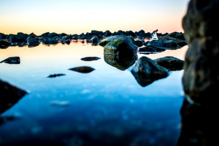 macro photography of rock formations surrounded by body of water photo