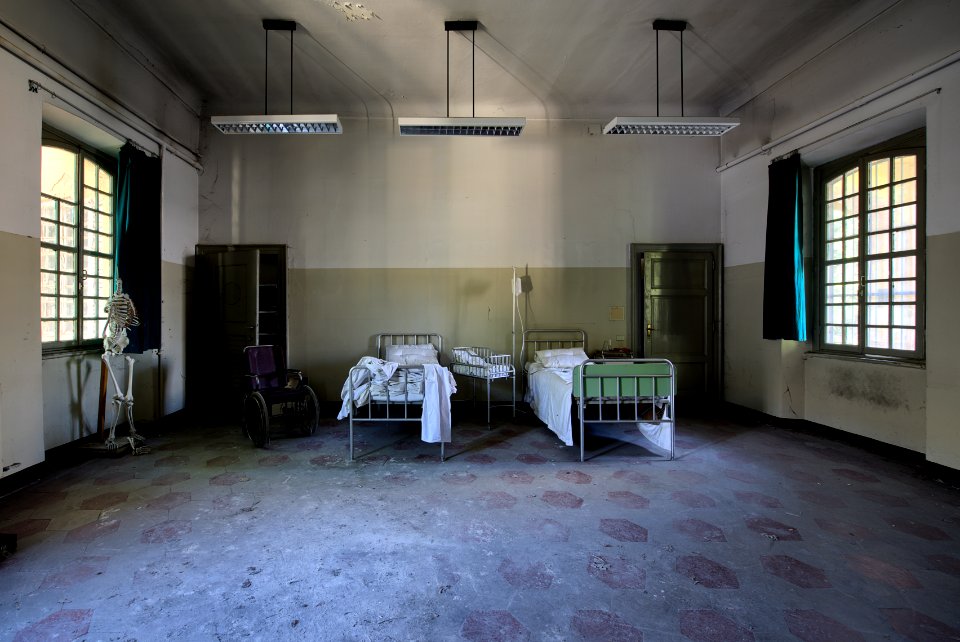 two hospital beds in spacious room under pendant lamps
