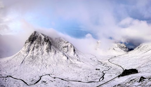 landscape photography of snow covered mountain under cloudy sky photo