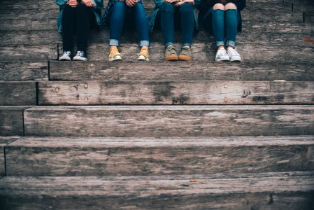 four people sitting on wooden stair photo