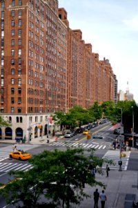 vehicles on road between buildings photo