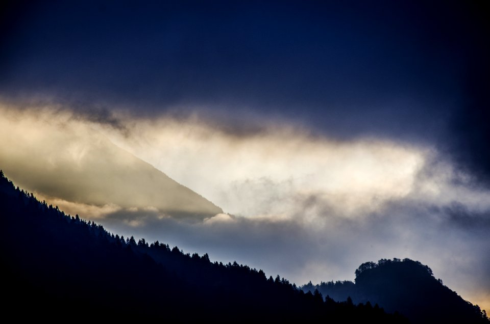 silhouette of mountain under clouds