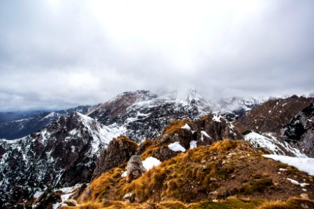 brown and white mountain under cloudy sky photo