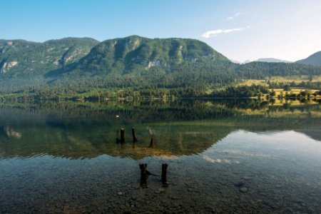 lake viewing mountain under blue and white skies photo