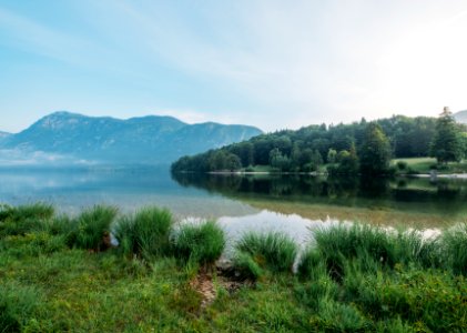 photo of lake across mountain during daytime photo