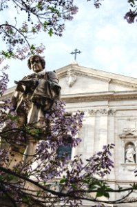 statue in front of white building during daytime photo