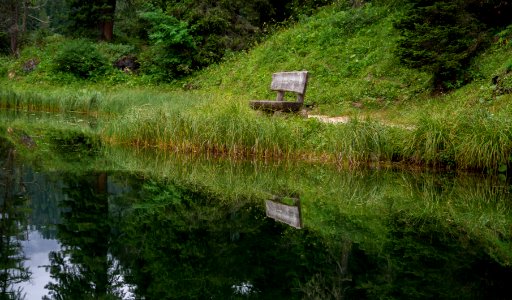 bench near body of water during daytime photo