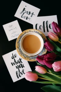 Motivational notes next to a cup of coffee. photo