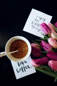 Love coffee, and "Enjoy the little things," notes next to a cup of coffee. photo