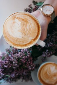 person holding white ceramic espresso cup photo