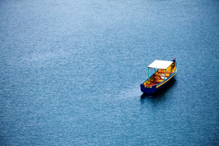 brown and blue boat on water at daytime photo