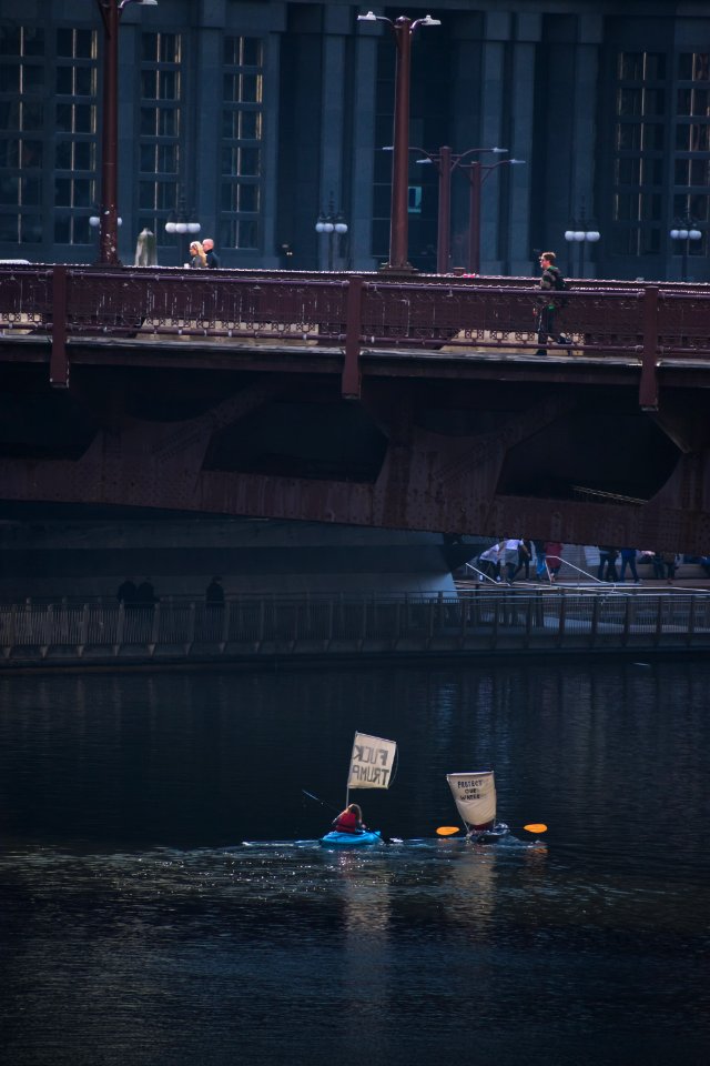 woman riding on blue kayak on body of water