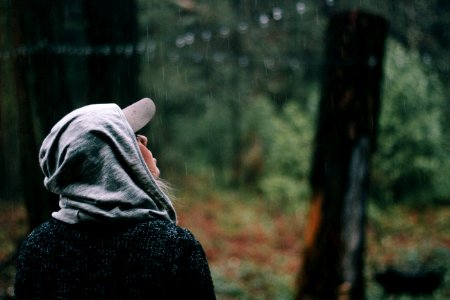 person looking at the rain drops photo