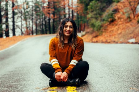 woman sitting on concrete road photo