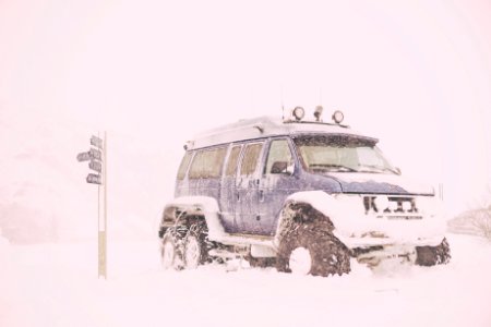 blue SUV covered with snow photo