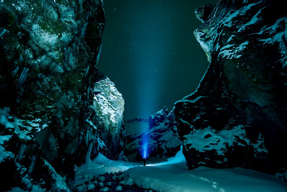 person standing surrounded by snowy mountain