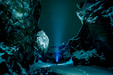 person standing surrounded by snowy mountain