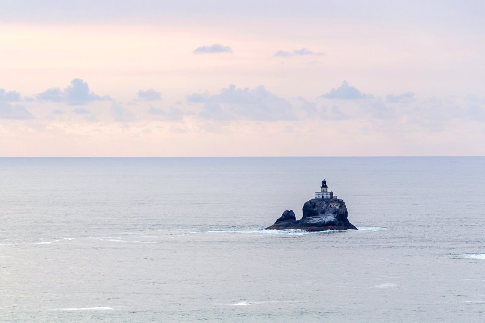 building on rocky cliff surrounded by the sea