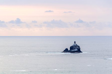 building on rocky cliff surrounded by the sea