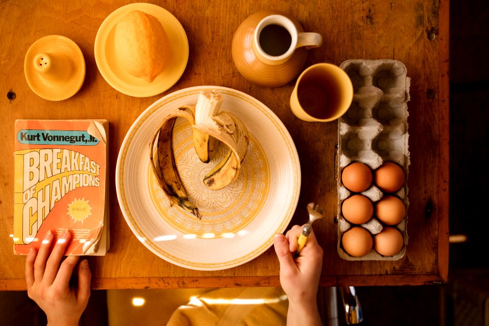 plate with banana and tray of eggs on table