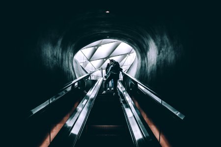 person standing on escalator photo